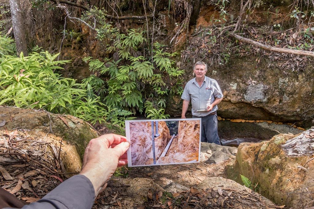 Graham standing in the creek near the pipeline intake