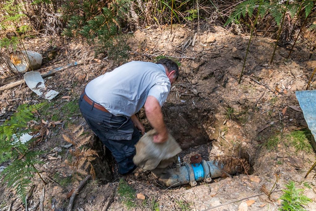 Graham inspecting one of the bleed-valves on the pipeline.