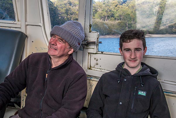 Graham and James sitting in the ferry boat crossing Lake St Clair, Cradle Mountain National Park, Tasmania