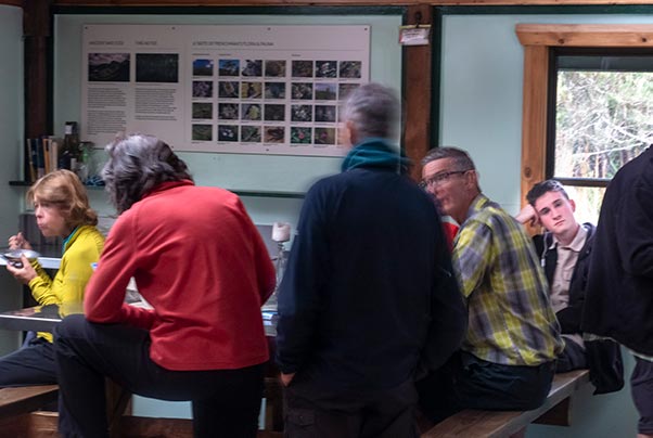 People sitting around the table  inside Lake Vera Hut