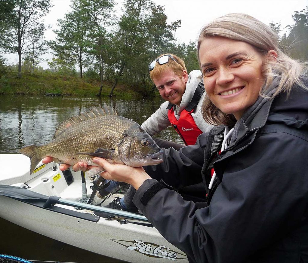 mark Locke of Secret River Tours with a client who has caught a large fish