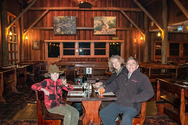 James, Christine and graham sitting at a dining table inside the Derwent Bridge hotel