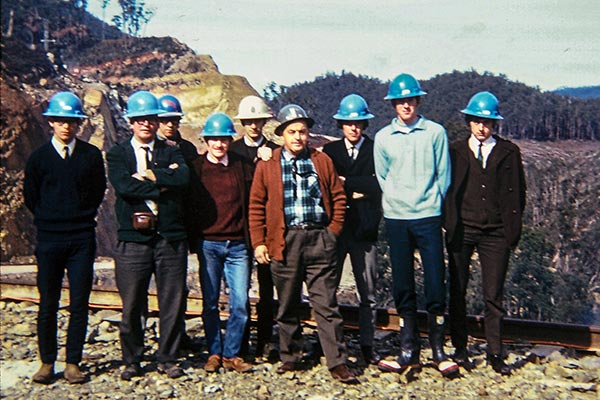 19602 photo of Graham with other employees of Hydro Tasmania. They are wearing hard hats..