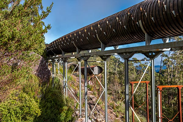 Wooden stave pipe high above the valley and in the background the decommissioned pipe made out of King Billy pipe.