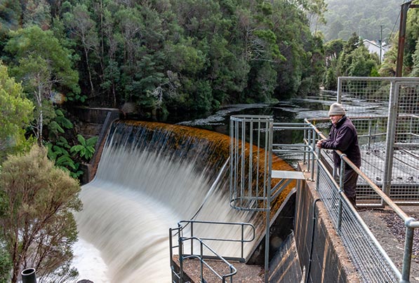 Graham standing on top of the weir below the lake Margaret Power Station