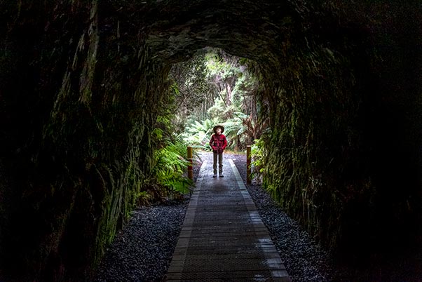 James standing in the mouth of the dark Spray Tunnel.