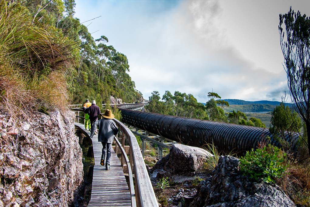 James and Graham walking along the boardwalk adjacent a long section of wood stave pipeline