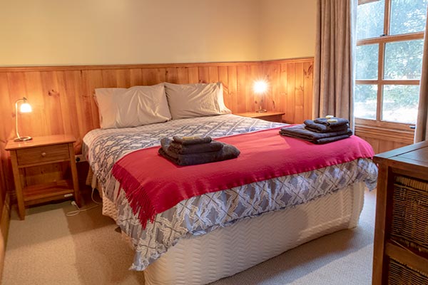 Queen-size bed in the first bedroom of Ah Moy self-contained cottage is wheelchair accessible.