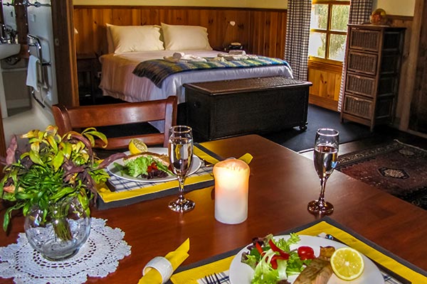Dinner for two on the dining table in Fon Hock studio spa cottage near Derby in Tasmania