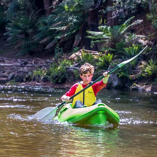 Young teenager kayaking down the Ringarooma River.