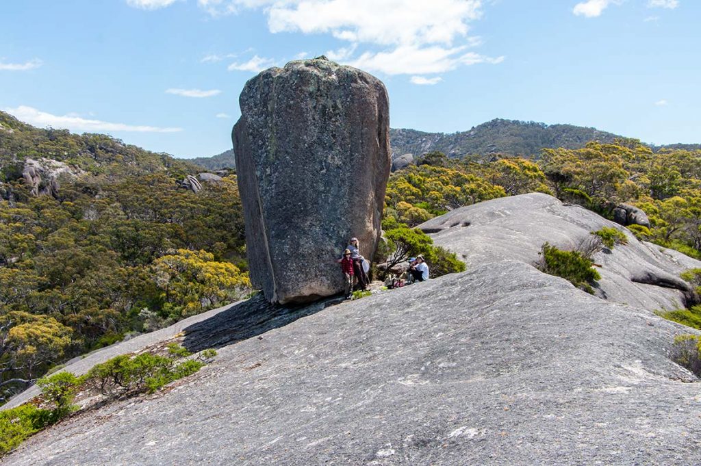 Cube rock is in profile view. Our group standing near the rock shows how massive the rock is.