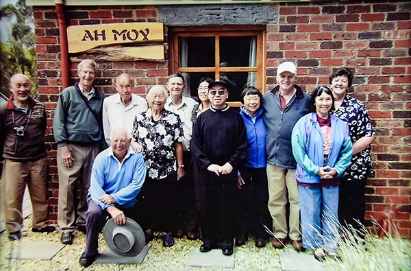 Ah Moy family in 2008 standing outside ah Moy cottage at Tin Dragon Cottages. The Ah Moy family were important in Henrys story.