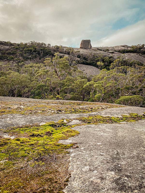 Looking out over a large slab of granite, the cube rock can be seen: Tasmania road trip
