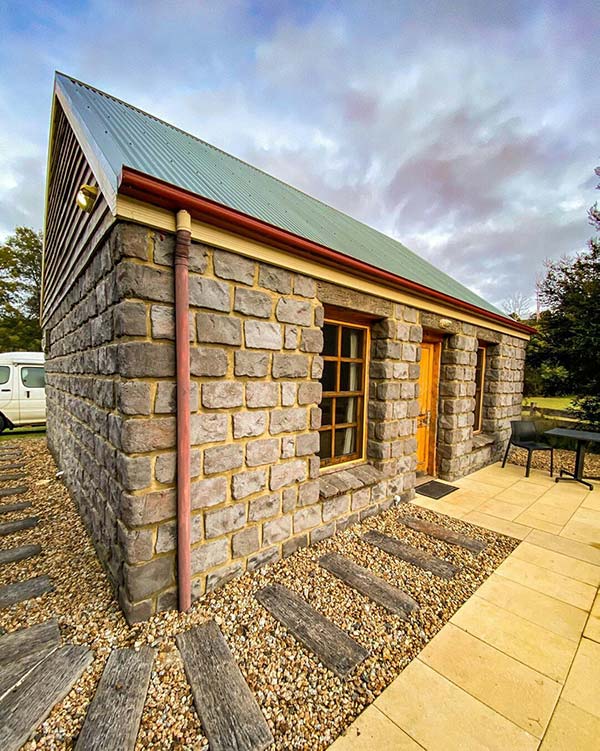Looking side on at Ah Back (blue stone) studio cottage at Tin Dragon Cottages - a must stay location on your road trip in Tasmania