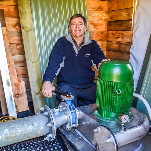 Graham turning the water flow valve to the micro hydro generator.