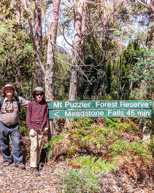 Graham and James standing in front of the sign that indicates the start of the walking track to Meadstone Falls.