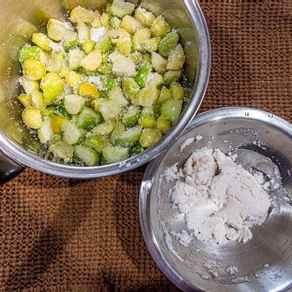 A saucepan contains the fruit, sugar and orange zest and the hydrated tapioca is in a small mixing bowl.