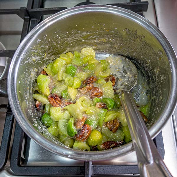 After the mixture in the saucepan becomes thick, the pecan nuts are added.
