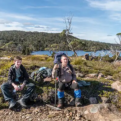 Graham and James sitting on the side of the Overland Track near Lake Windermere. 