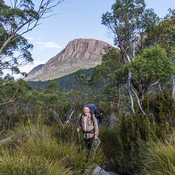 Graham on the track to Ka Ora hut with Cathedral mountain in the background on day 4 of the Overland Track walk.