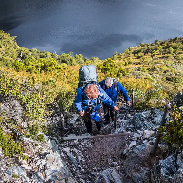 Looking down to Crater Lake, Christine is climbing the steep steps to Marion's Lookout on the Overland Track.
