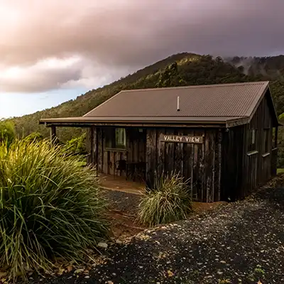 Sunset over a small timber cottage