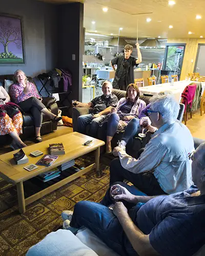 The art retreat group relax in lounge sofas with a wine after dinner