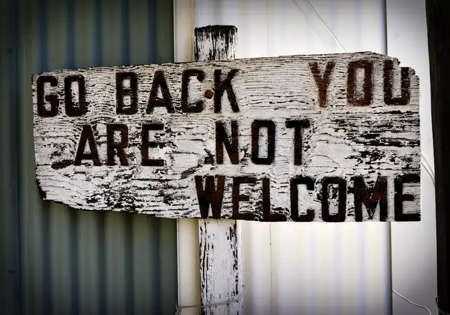 An old sign says, " Go back you are not welcome" . The small town welcome.