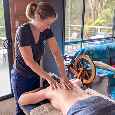 Di is giving a client a massage.