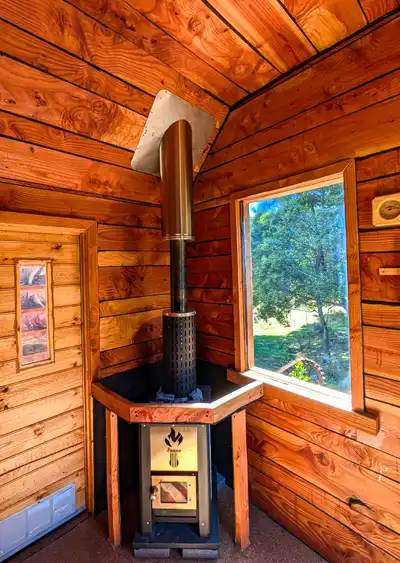Inside the Tailrace Sauna showing the wood-fired sauna furnace