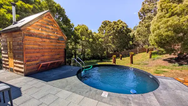 Landscape image of the Tailrace Sauna showing the buildings and the plunge pool