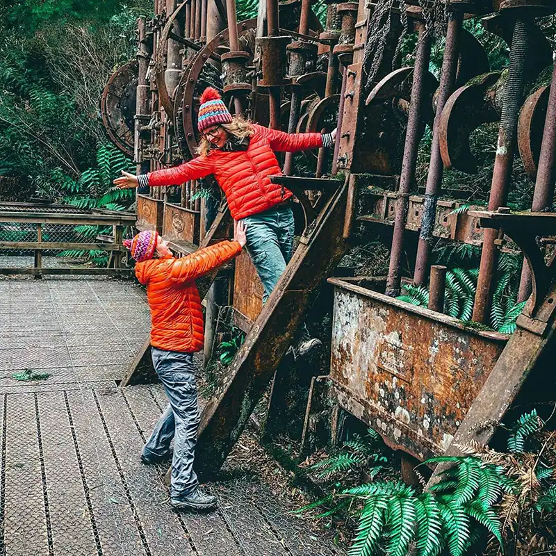 Two women are climbing the Anchor stampers at the old mine site in North East Tasmania