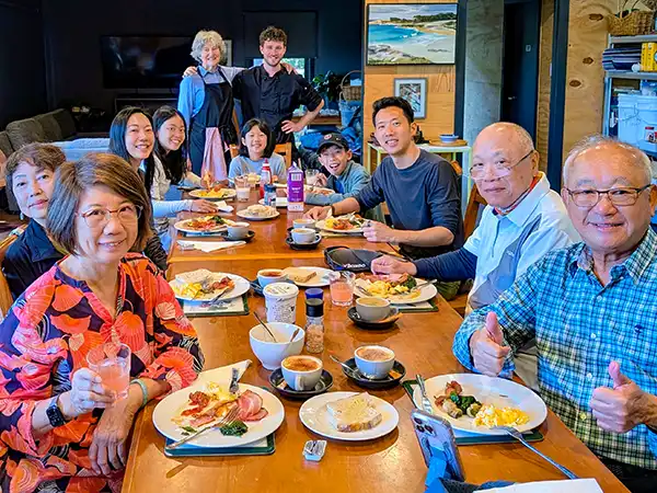 A group pf guests ating breakfast in The Barn at Tin Dragon Cottages in North Eat Tasmania