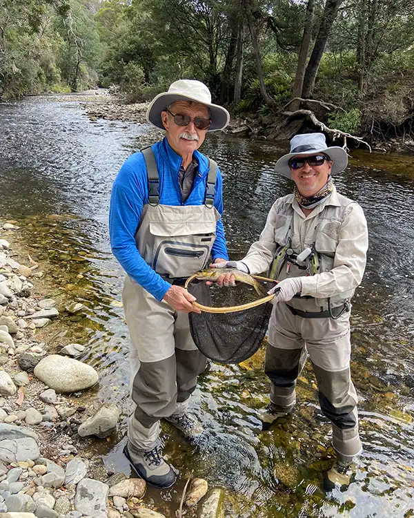 Scott Murpy and clint sith a trout they just caught