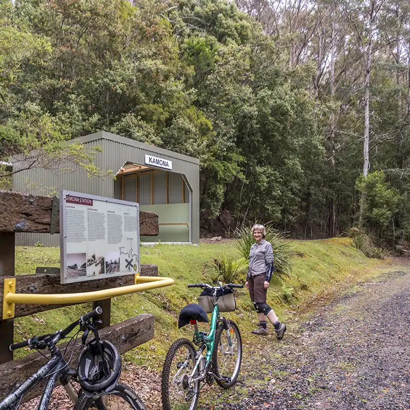 Two bokes and a woman are in front of the Kamona station on the North East Rail Trail