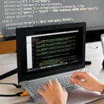 a person is sitting in front of a laptop - featured image