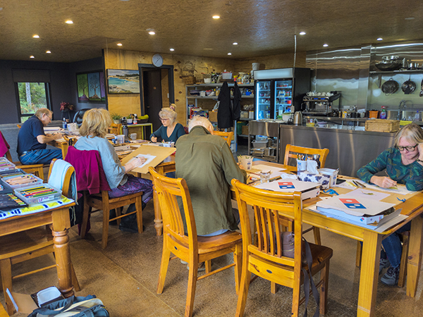 A small group of artists working in The Barn at Tin Dragon Cottages in North EastTasmania